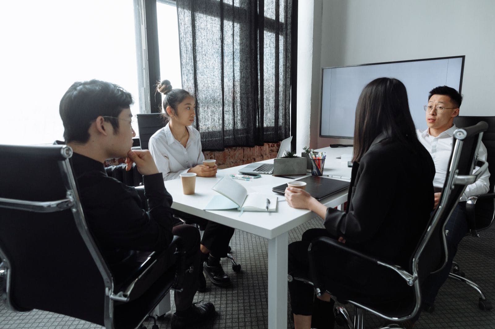 Indonesian investment professionals in discussion at a modern office table